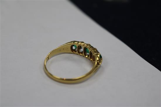 A George V 18ct gold emerald and diamond five stone half hoop ring, size P.